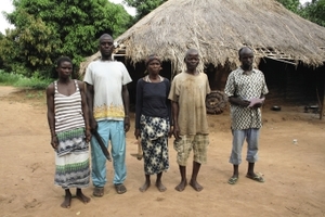‘They'll have to kill us first’.  The land of villagers in Kitica, Cabo Delgado province, is under threat from a local landgrabber.  They pose with machete, hoe and a coil of homegrown tobacco, the trappings of home – and self defence.   Hazel Healy