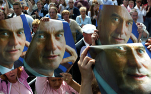 Mass outpouring: supporters hold images of Pim Fortuyn aloft on the streets of Rotterdam while waiting to attend his lying in state ceremony, May 2002. Jerry Lampen / REUTERS