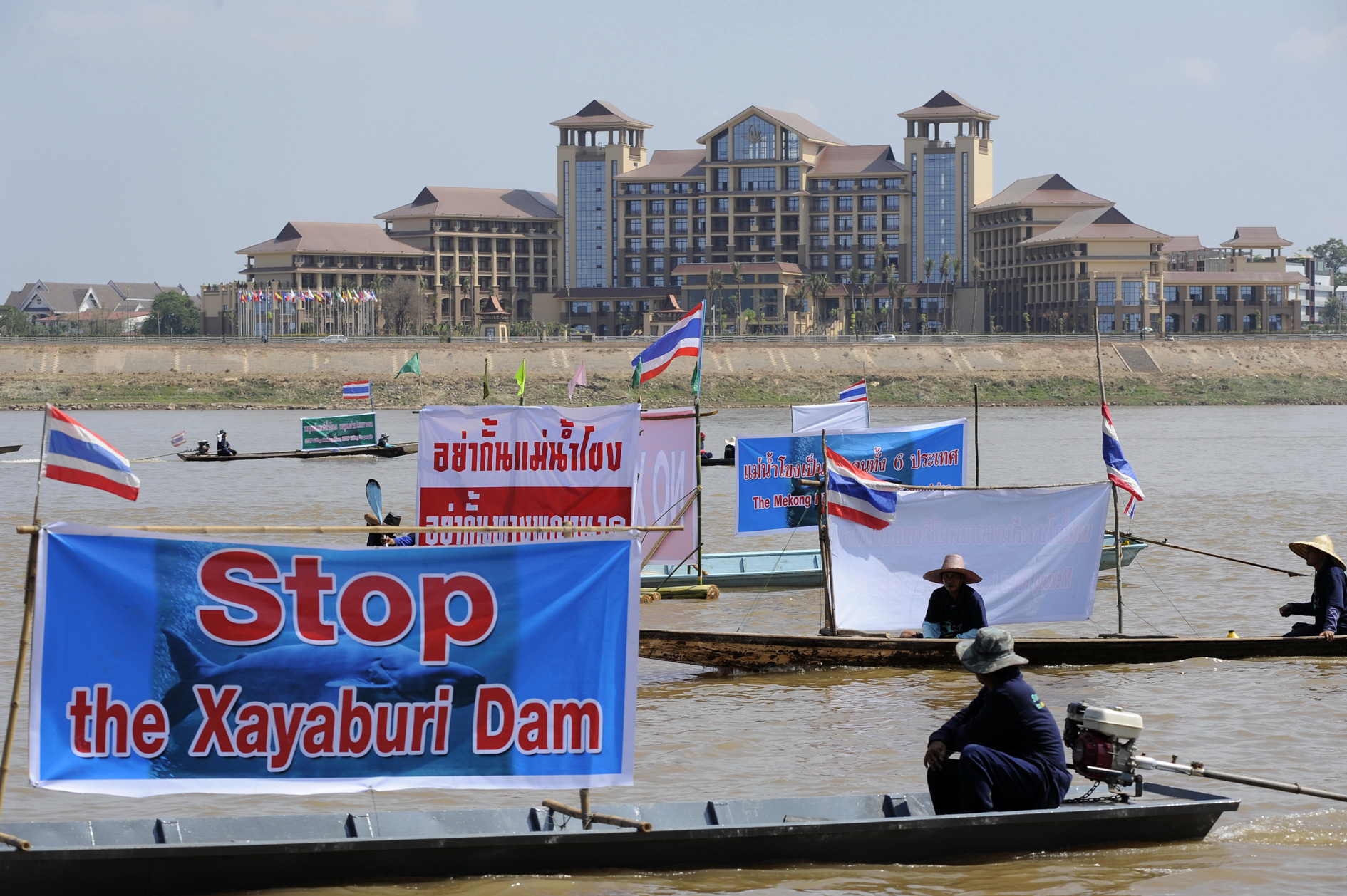 Thai NGOs stage a boat protest on the Mekong River in Laos. The convention centre on the opposite bank was hosting a major international conference.