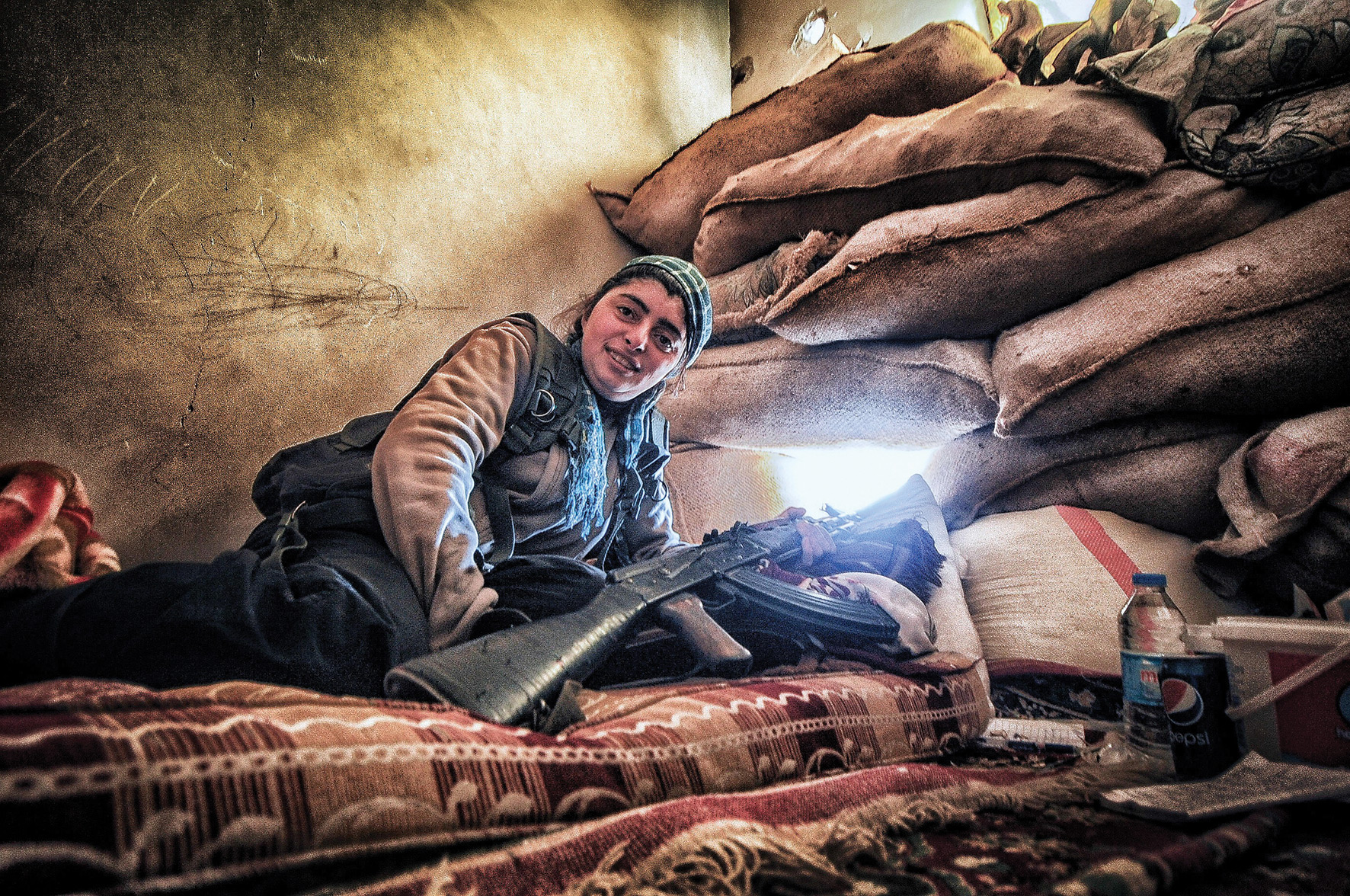 A fighter at her post, defending Kurdish ground troops as they advance against ISIS.