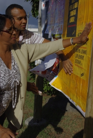 Pasting posters in a campaign for mother-tongue education, introduced for the first time in 2012 Lindsey Collen