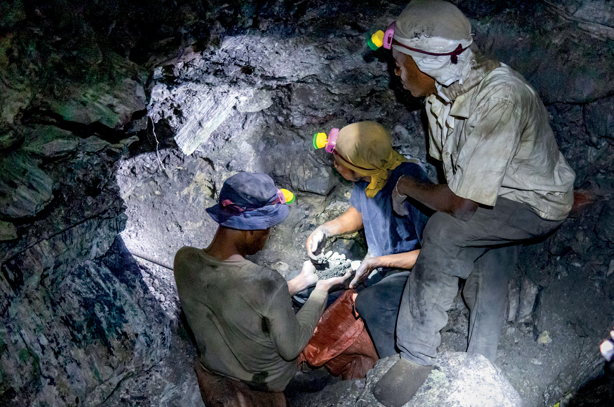 Informal miners collect rock containing cobalt at the bottom of a shaft near the mining hub of Kolwezi.