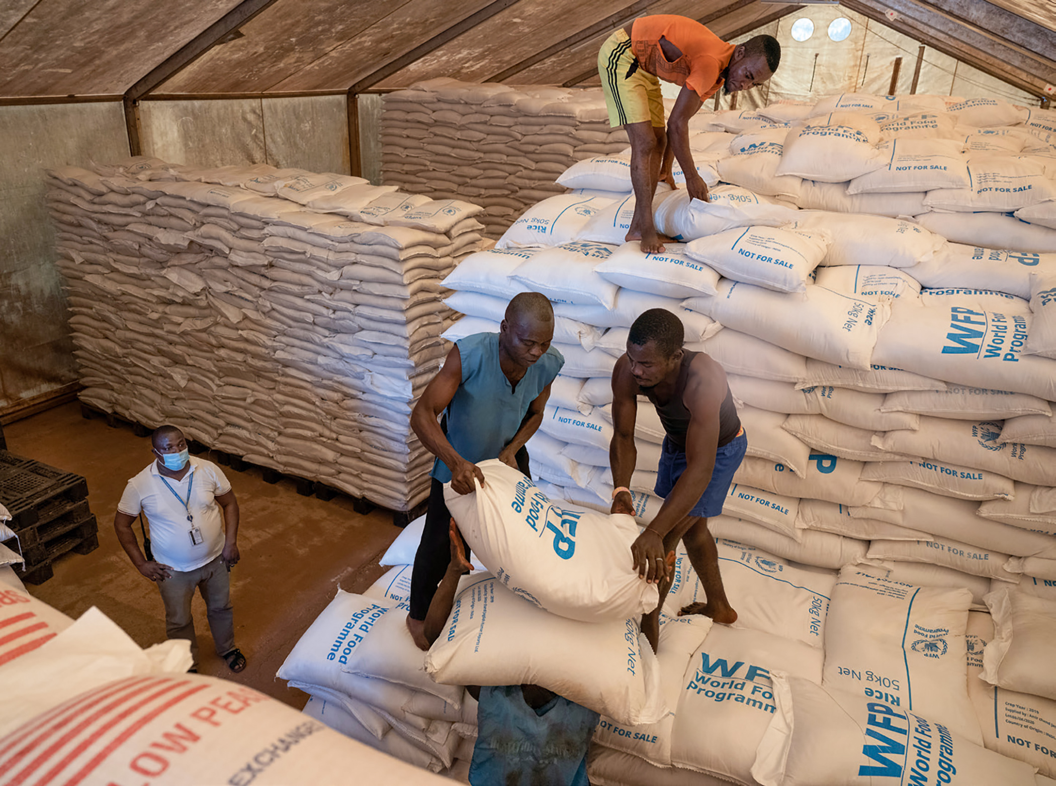 Labourers load sacks of food onto a truck at the World Food Programme headquarters in Bambari, Central African Republic.