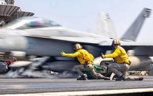 US Navy sailors signal all go for launch to a Super Hornet fighter jet off the USS Harry S Truman aircraft carrier, operating in the Red Sea, on 13 March 2025. Photo: MC2 Logan Mcguire/US Navy Photo/Alamy Stock Photo