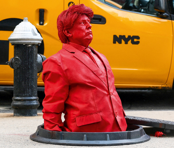 In an age of despair, monsters rise from the gutter. Artist James Colomina’s sculpture of Donald Trump crawling from a Manhattan manhole unveiled on 23 July 2024, blurs the line between street art and social warning. Photo: Kylie Cooper/Reuters