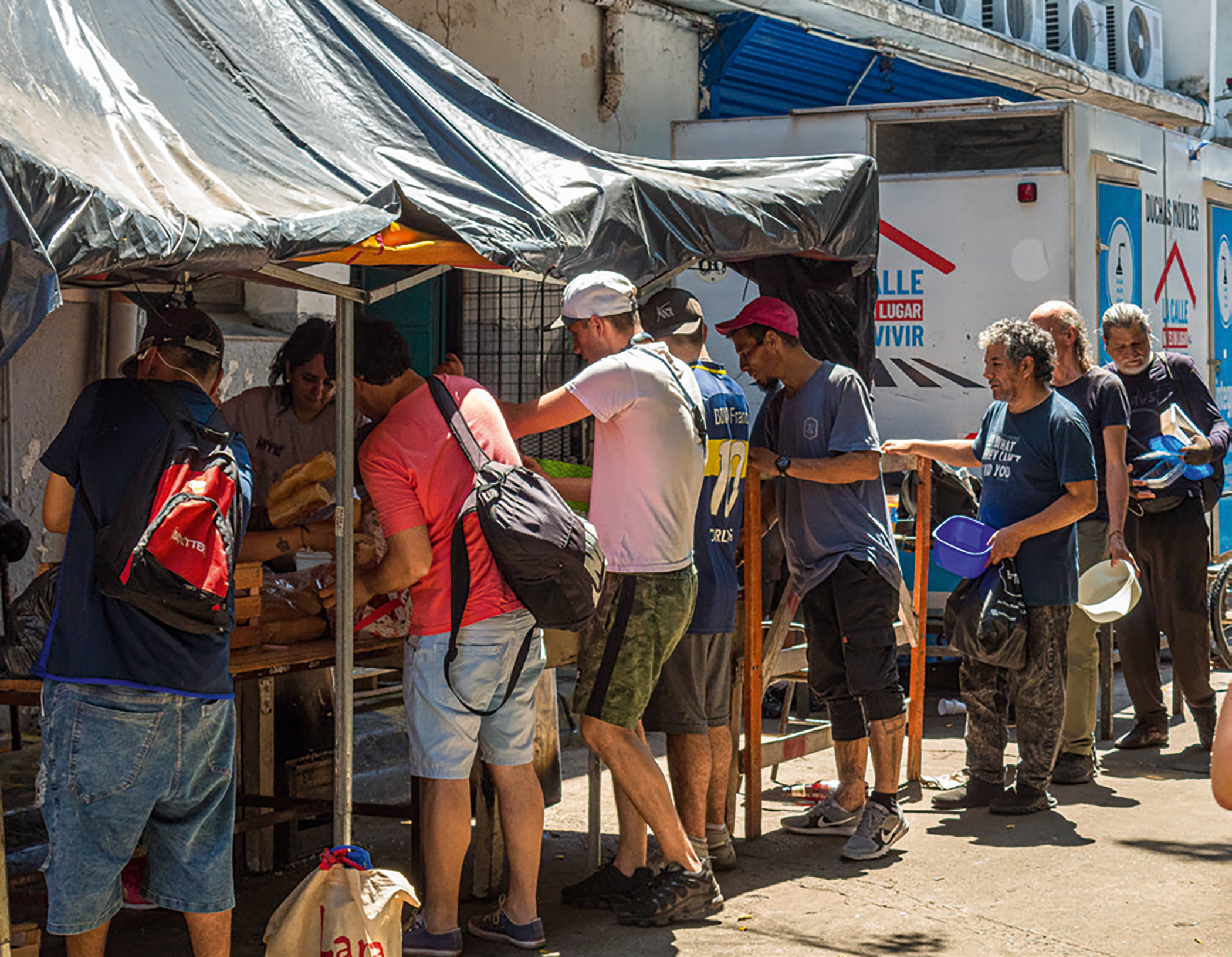 People line up for food at a soup kitchen run by the Union of Workers of the Popular Economy in the neighbourhood of Constitución, Buenos Aires, in November 2024. People line up for food at a soup kitchen run by the Union of Workers of the Popular Economy in the neighbourhood of Constitución, Buenos Aires, in November 2024.