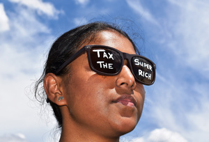 Greenpeace activists call for the super-rich to pay their fair share as G20 finance ministers meet in Cape Town, South Africa, on 24 February 2025.Photo: Natanya Harrington/Greenpeace