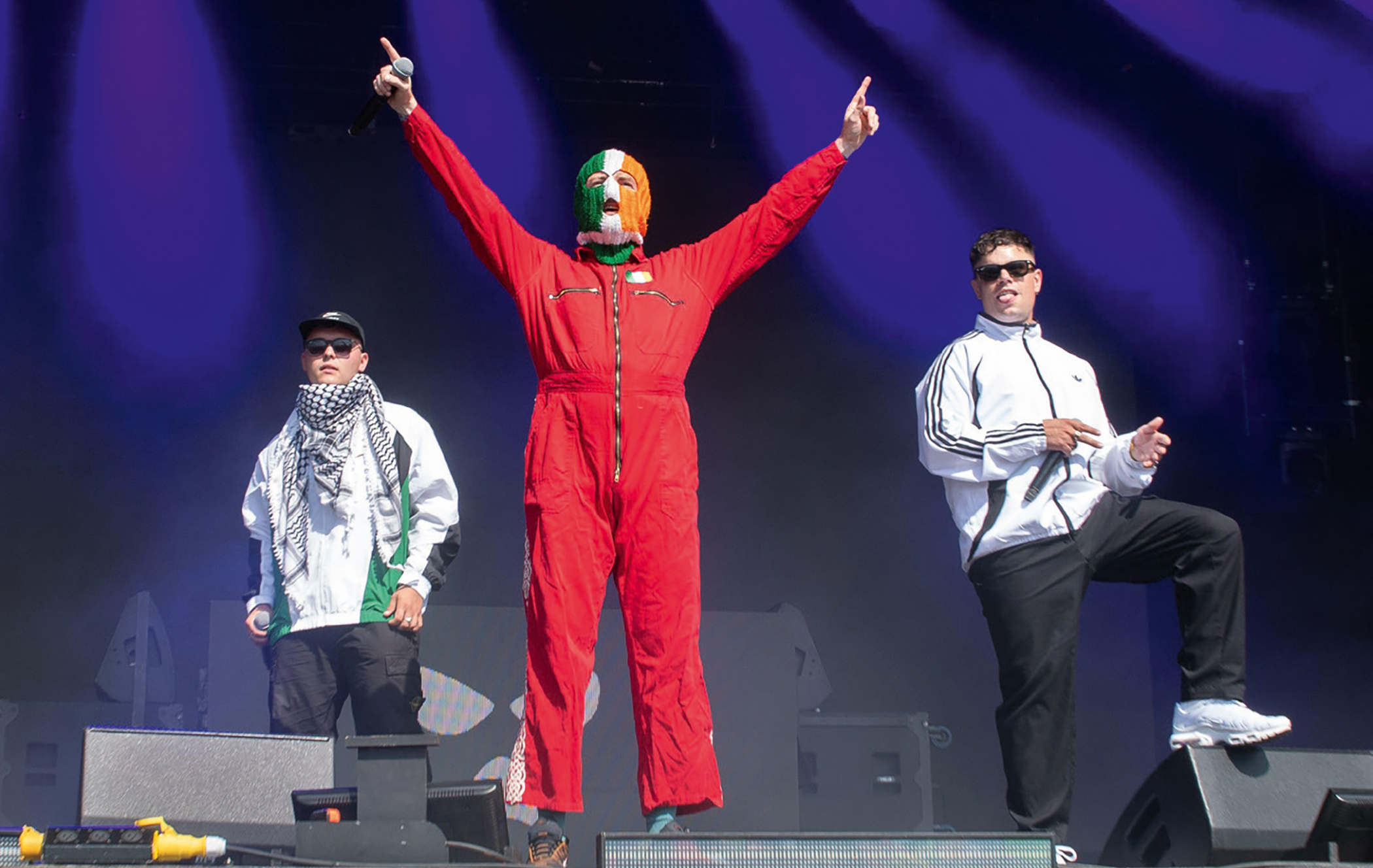 Left to right: Kneecap members Mo Chara, DJ Próvaí and Móglaí Bap on stage at Glastonbury Festival on 28 June 2025.