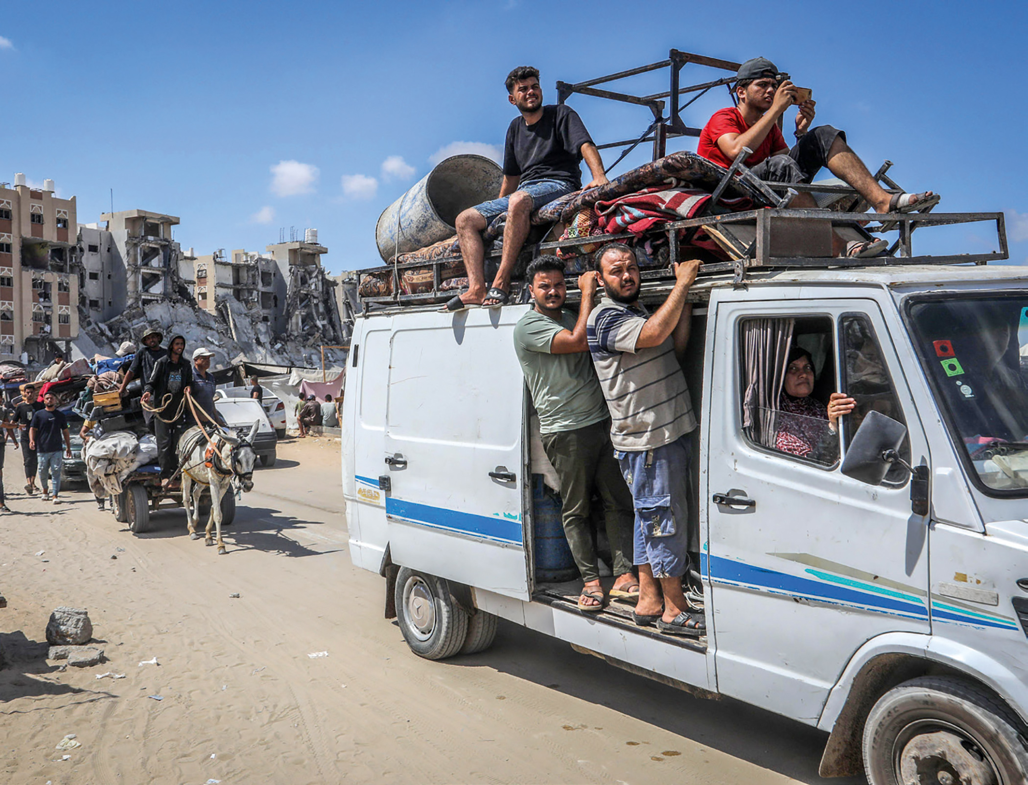 Palestinians drive past bombed-out homes as they flee Israeli bombardment in Khan Younis, Gaza, on 11 August 2025. Almost the entire population of Gaza – around 1.9 million people out of 2 million – has been forcibly displaced during the genocide. Palestinians drive past bombed-out homes as they flee Israeli bombardment in Khan Younis, Gaza, on 11 August 2025. Almost the entire population of Gaza – around 1.9 million people out of 2 million – has been forcibly displaced during the genocide.