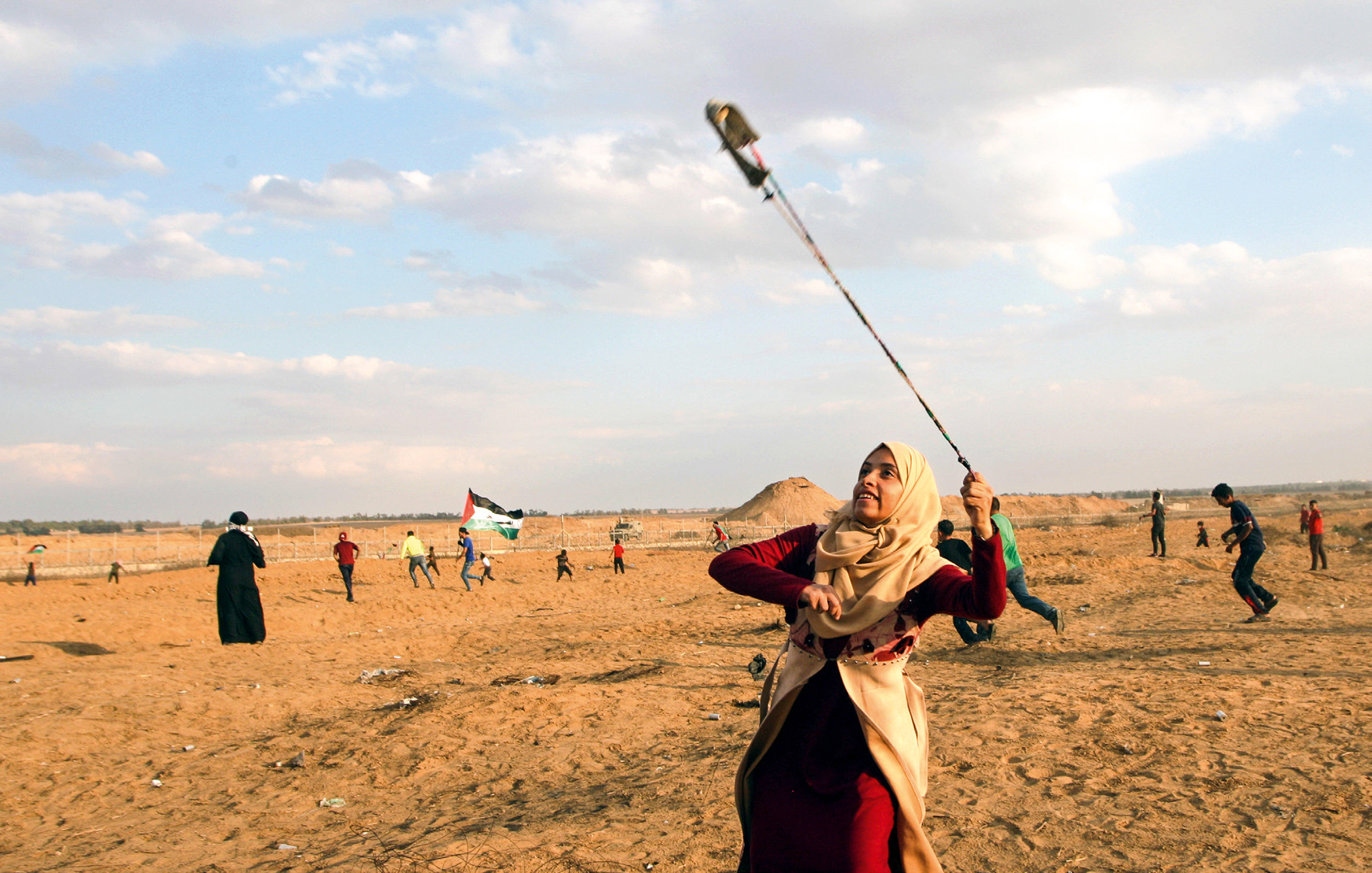 A protester uses a slingshot to hurl stones at the Gaza border on 25 October 2019 during the Great March of Return. The year long protest movement saw thousands of Palestinians march towards the border to demand the right of return to their ancestral homelands. In response Israeli soldiers killed 223 Palestinian protesters.