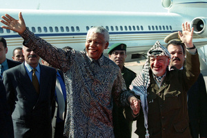 Palestinian Liberation Organization chairman Yasser Arafat and former South African president Nelson Mandela grasp hands and wave at Gaza international airport on 19 October 1999. Mandela supported the Palestinian struggle, famously saying that: ‘We know too well that our freedom is incomplete without the freedom of the Palestinians.’Photo: Reuters