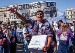 A worker from the FATE tyre factory holds a collection box to support the struggle after the 50-year-old factory was shut down.Photo: Patricio A Cabezas