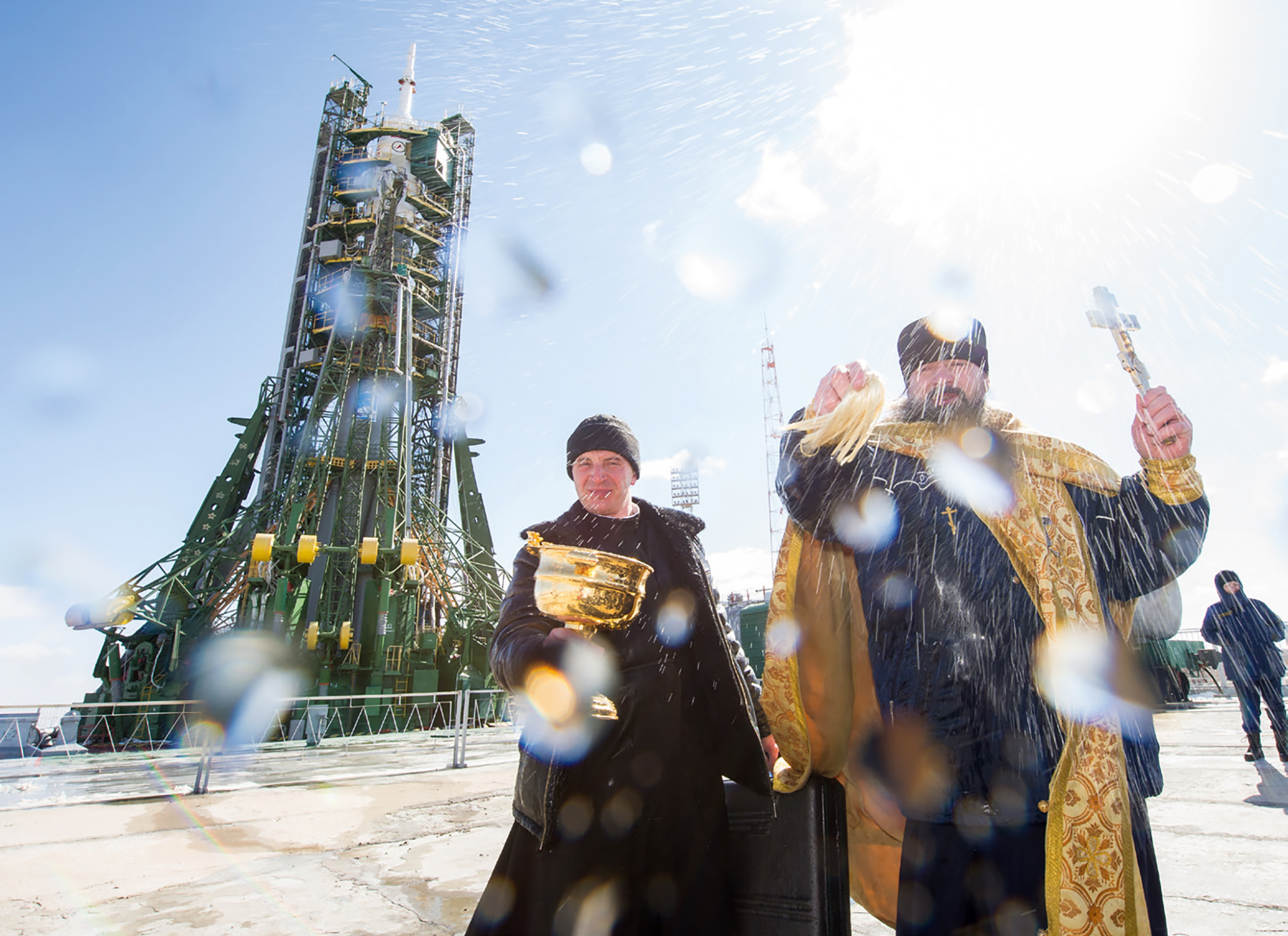 An Orthodox priest blesses members of the media at Russia’ s Baikonur Cosmodrome launch pad in Kazakhstan, March 2016. Since 1994 it has been tradition for a priest to bless the crew and the rocket before each launch.