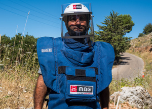 Ashraf Hijazi, a deminer with the Mines Advisory Group, wears a protective suit and visor to enter a minefield in Chouf Biosphere Reserve in Mount Lebanon, on 15 July 2026. The reserve is close to being declared safe after years of demining operations.Photo: Gergana Krasteva