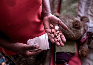 Gabatswane Rodgers holds a handful of antiretroviral pills at her home in Selibe Phikwe, Botswana in 2018.Photo: Tommy Trenchard/Panos Pictures